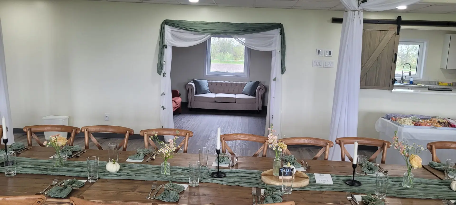 The full length of the hall, decorated for a wedding by the couple and their suppliers